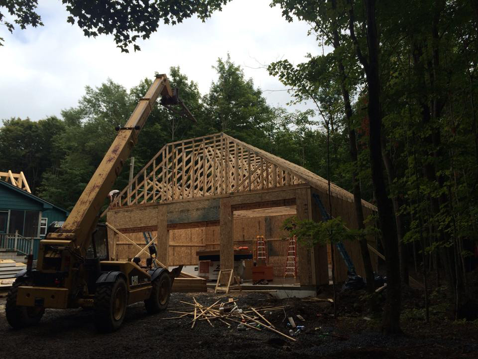 Installation of trusses over wall SIPs for a structural panel garage in New York