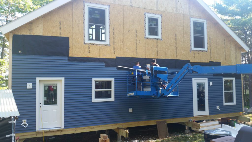 Vinyl siding being installed over SIPs