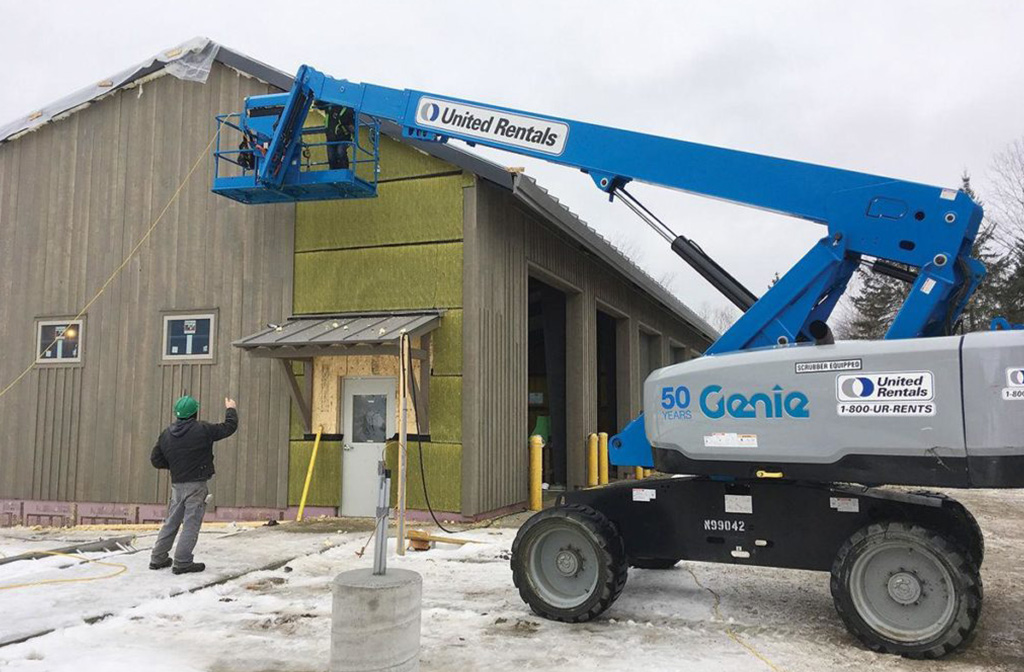 Exterior build in progress with a manlift for a commercial project in Stowe